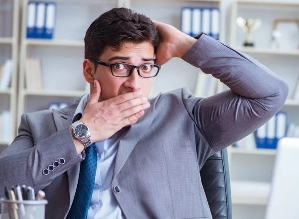 Businessman sweating excessively smelling bad in office at workp