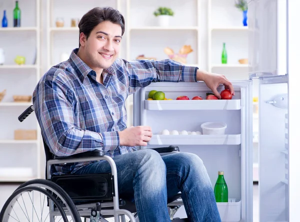Jonge gehandicapte man die de koelkastdeur opent — Stockfoto