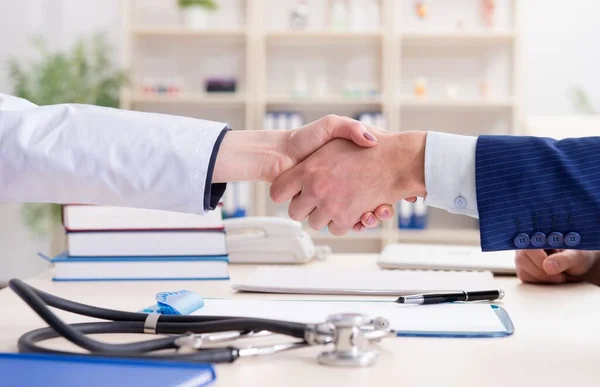 Man signing medical insurance contract