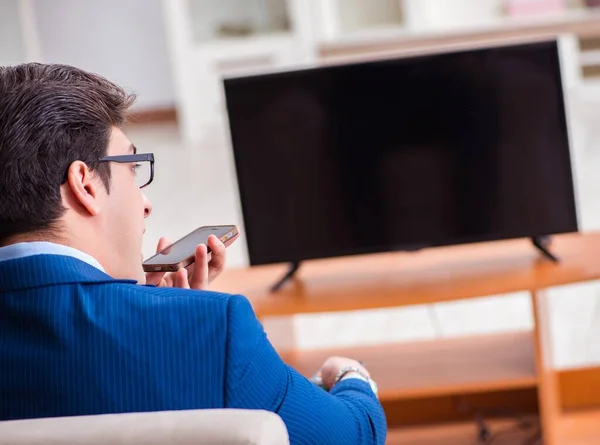 Businesman watching tv in office — Stock Photo, Image