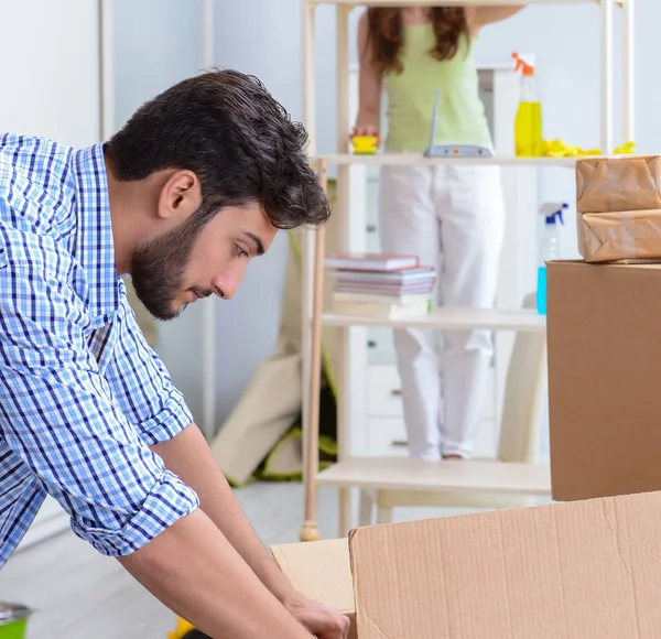 Young family unpacking at new house with boxes — Stock Photo, Image