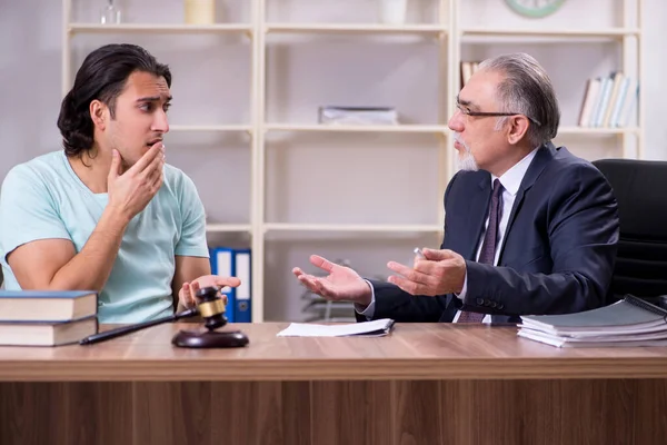 Young man visiting experienced male lawyer — Stock Photo, Image