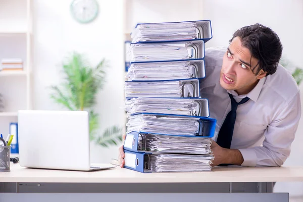 Giovane dipendente maschio infelice con il lavoro eccessivo — Foto Stock