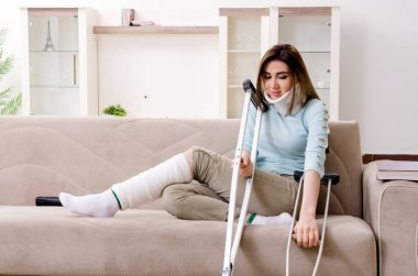 Araba kazasından sonra evde acı çeken genç bir kadın.