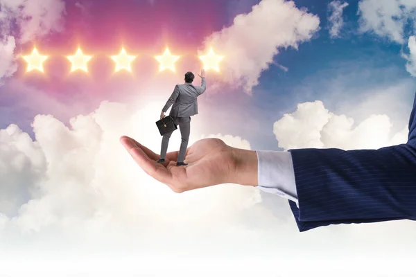 Businessman held on hand reaching out for stars — Stock Photo, Image