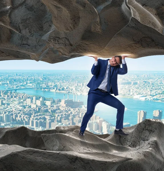 Businessman supporting stone under pressure — Stock Photo, Image