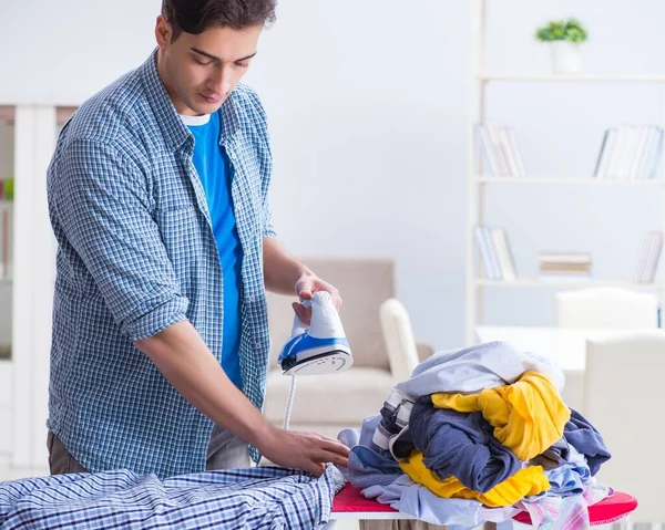 Young man husband doing clothing ironing at home — Stock Photo, Image