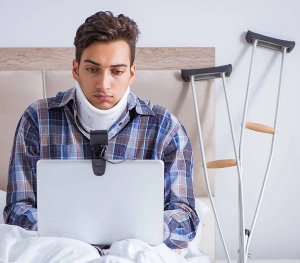 The injured man chatting online via webcam in bed at home