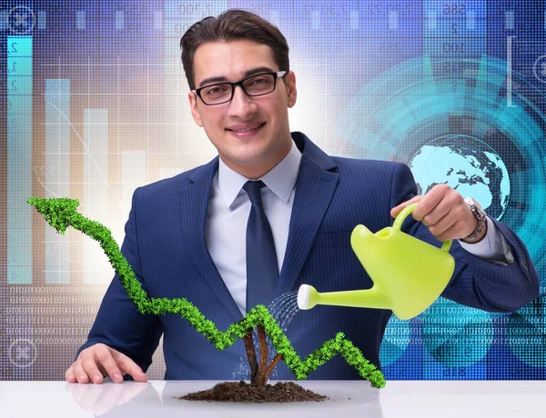 The businessman in investment concept watering financial line ch — Stock Photo, Image