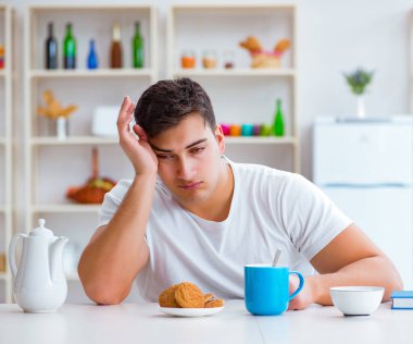 Fazla mesai sonrası kahvaltıda uyuyan bir adam.