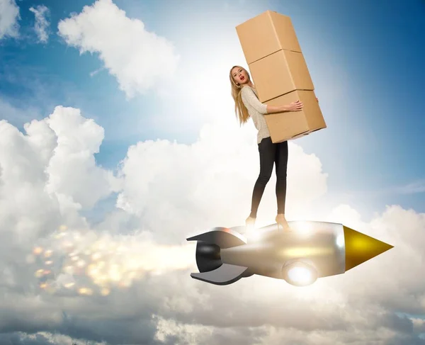 Woman in fast box delivery service on rocket — Stock Photo, Image