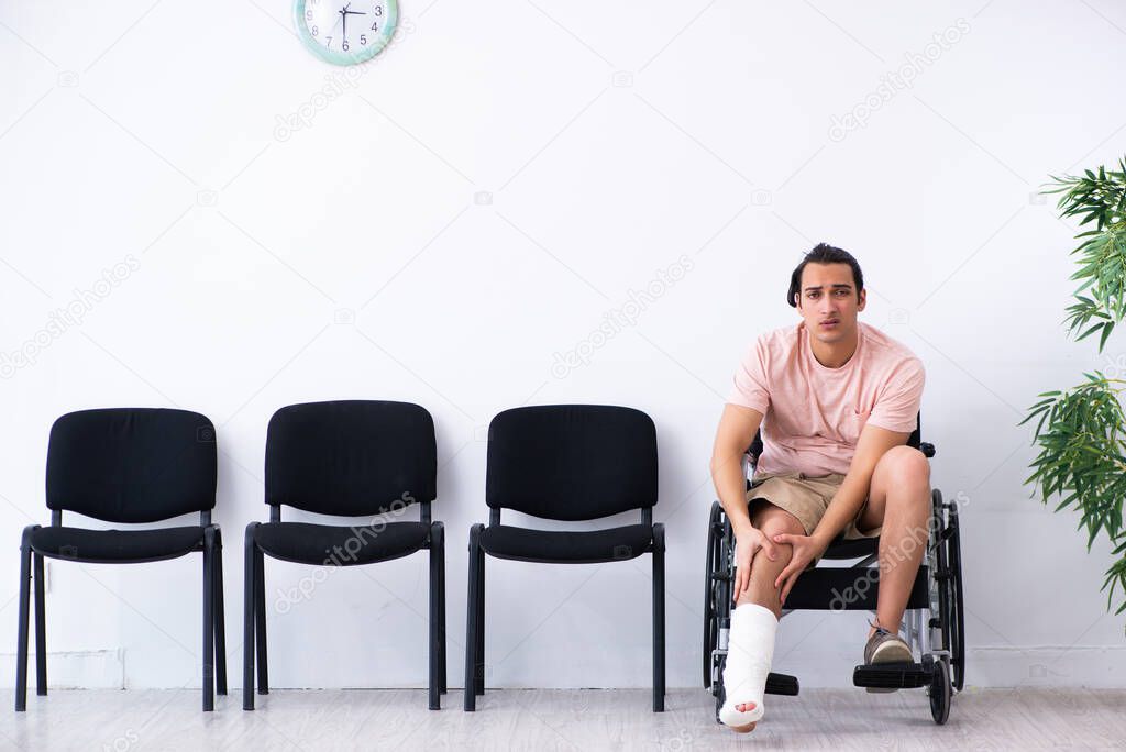 Young injured man waiting for his turn in hospital hall