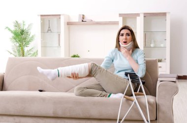 Araba kazasından sonra evde acı çeken genç bir kadın.