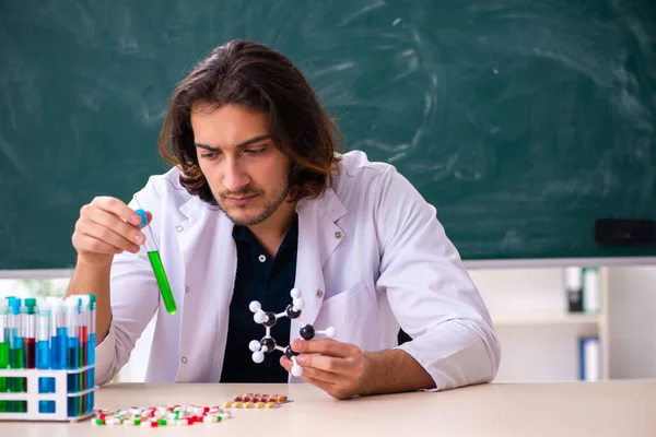 Young male scientist sitting in the classroom — Stock Photo, Image