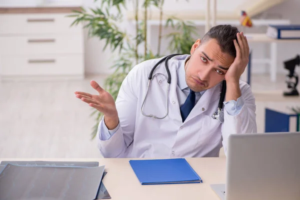 Young male doctor working in the clinic — Stock Photo, Image