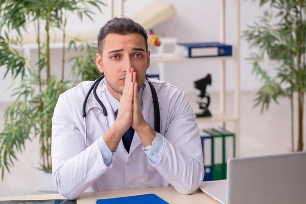 Young male doctor working in the clinic — Stock Photo, Image