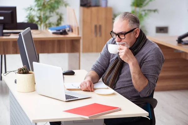 Gammal manlig anställd som arbetar hemifrån under en pandemi — Stockfoto