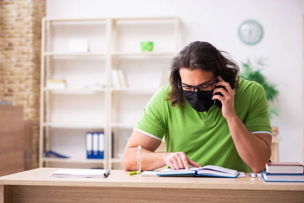 Young man student studying at home in self-isolation concept