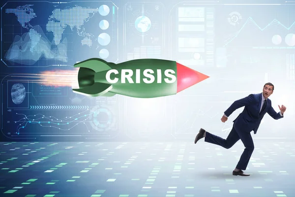 Concept of crisis with businessman chased by rocket — Stock Photo, Image
