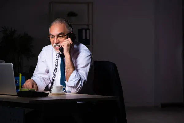 Viejo empleado trabajando hasta tarde en el lugar de trabajo —  Fotos de Stock