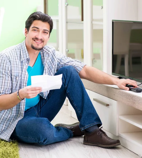 Young man husband repairing tv at home