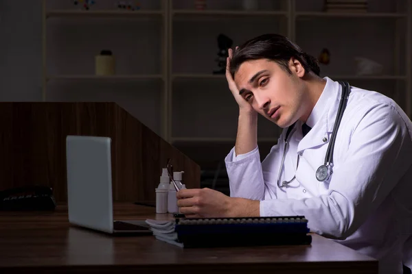 Young male doctor in the hospital at night — Stock Photo, Image