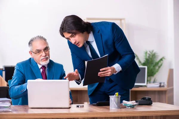 Jóvenes y viejos empleados trabajando juntos en la oficina — Foto de Stock