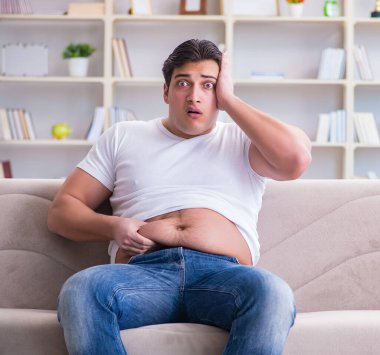 Diyet konseptinde fazladan ağırlık çeken adam.