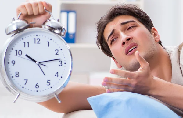 Man having trouble waking up with alarm clock — Stock Photo, Image