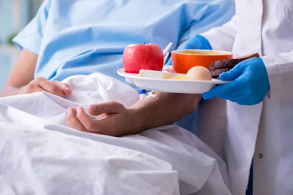 Paciente do sexo masculino que come alimentos no hospital — Fotografia de Stock