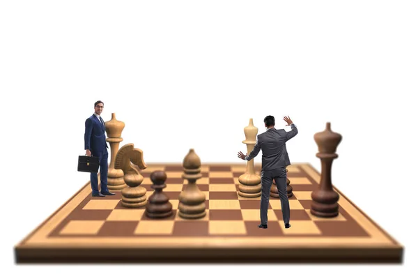 Empresário em grande tabuleiro de xadrez em conceito de estratégia — Fotografia de Stock