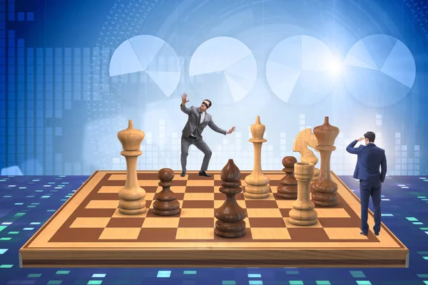 Businessman in large chess board in strategy concept — Stock Photo, Image