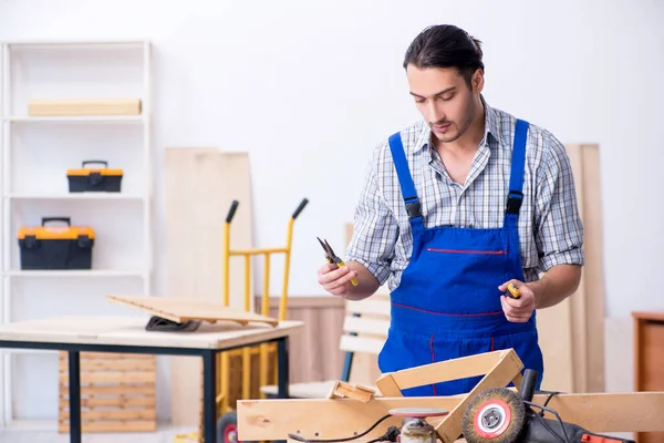 Jonge mannelijke timmerman die binnen werkt — Stockfoto