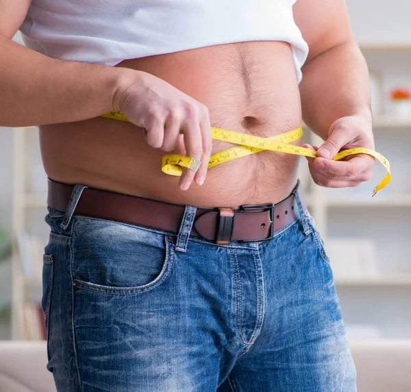 Man suffering from extra weight in diet concept — Stock Photo, Image