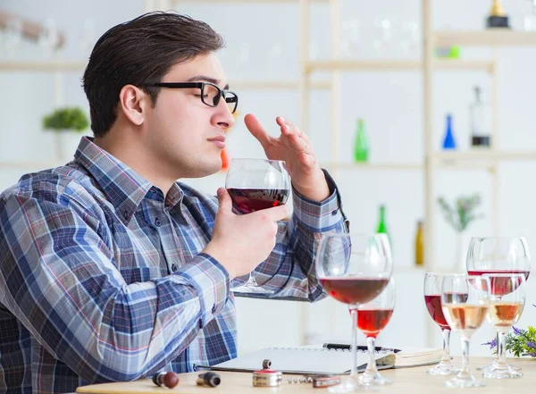 Professional sommelier tasting red wine