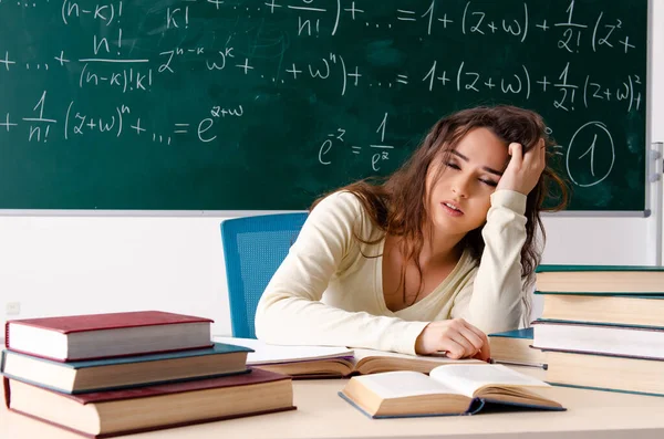 Young female math teacher in front of chalkboard — Stock Photo, Image