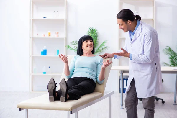 Mulher velha visitando jovem médico dentista — Fotografia de Stock