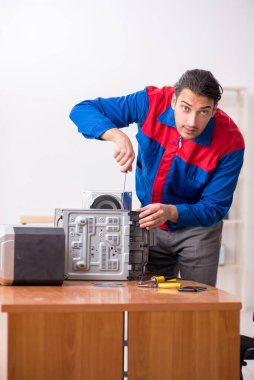 Müzik yüksek kurgu sistemini tamir eden genç mühendis