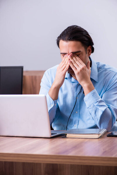 Call center operator working at his desk