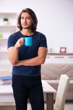 Evden çalışan genç bir adam.