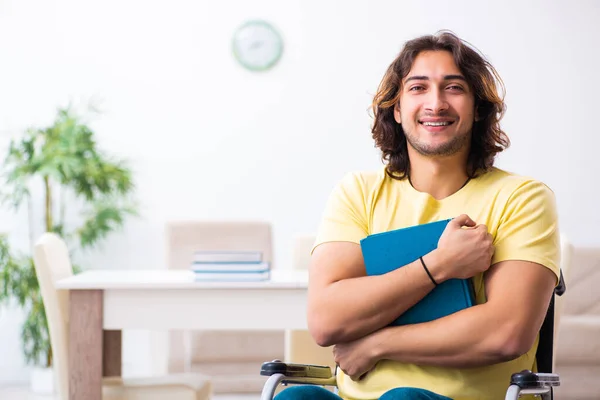 Male disabled student preparing for exams at home