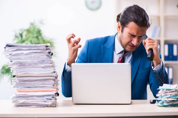 Young male employee unhappy with excessive work