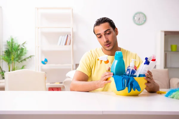 Young male contractor doing housework at home