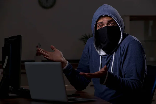 Male hacker hacking security firewall late in office — Stock Photo, Image