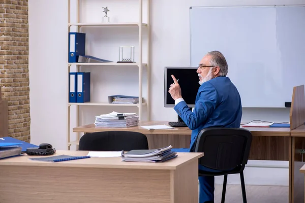 Old male boss employee working in the office