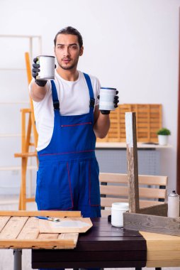 Genç erkek müteahhit atölyede çalışıyor.