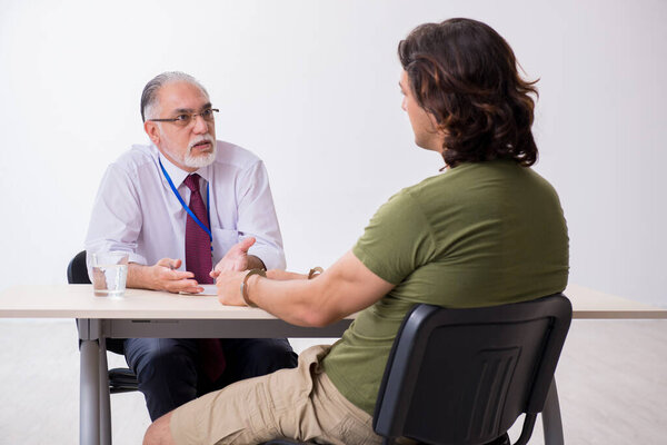 Young man meeting with advocate in pre-trial detention