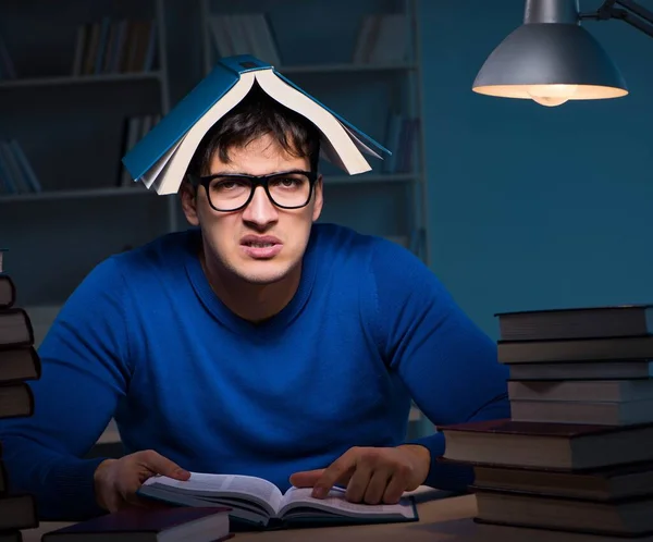 Estudante se preparando para exames tarde da noite na biblioteca — Fotografia de Stock