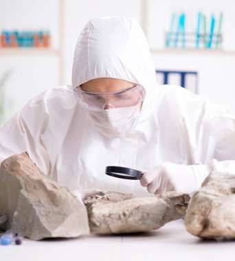 Bilimadamları laboratuarda taş örnekleri arıyor.