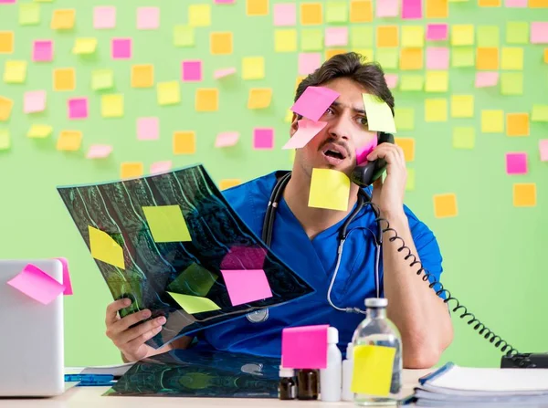 Young doctor with many reminders and urgent work — Stock Photo, Image